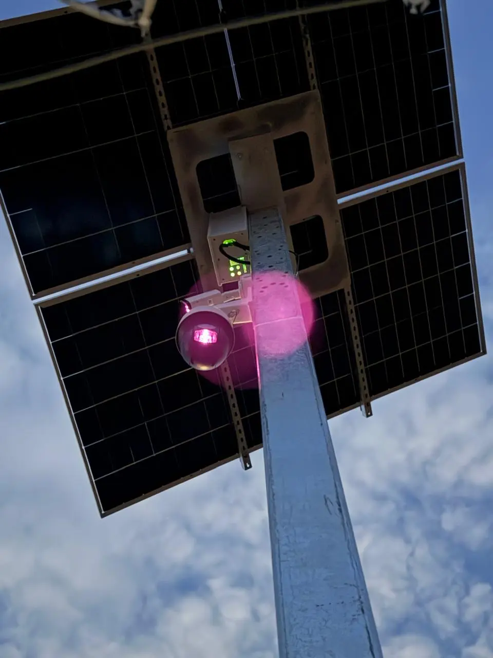 Solar-powered surveillance camera operating after dark