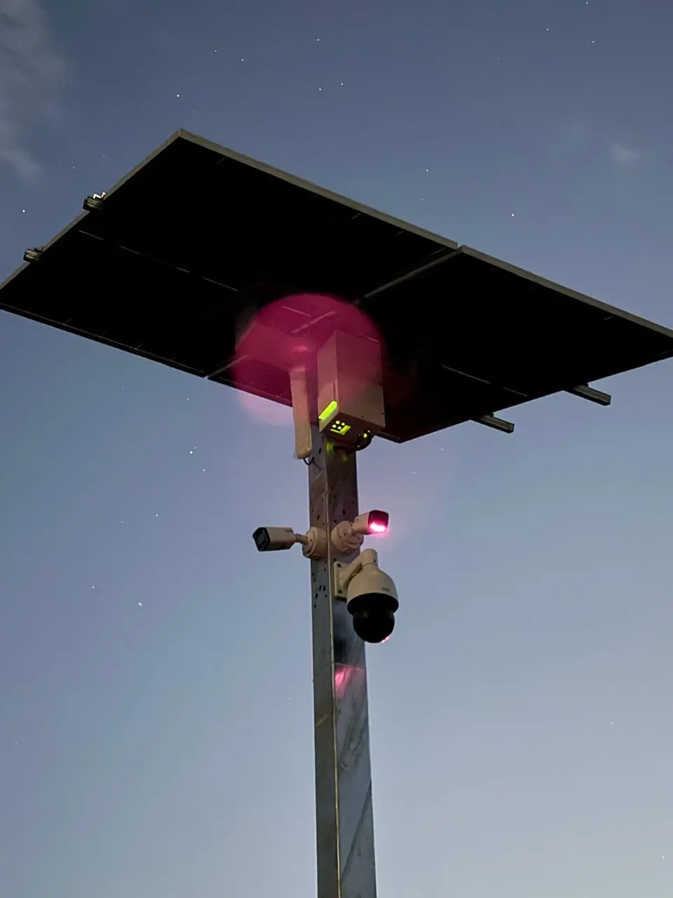Solar-powered surveillance system mounted on an elevated pole